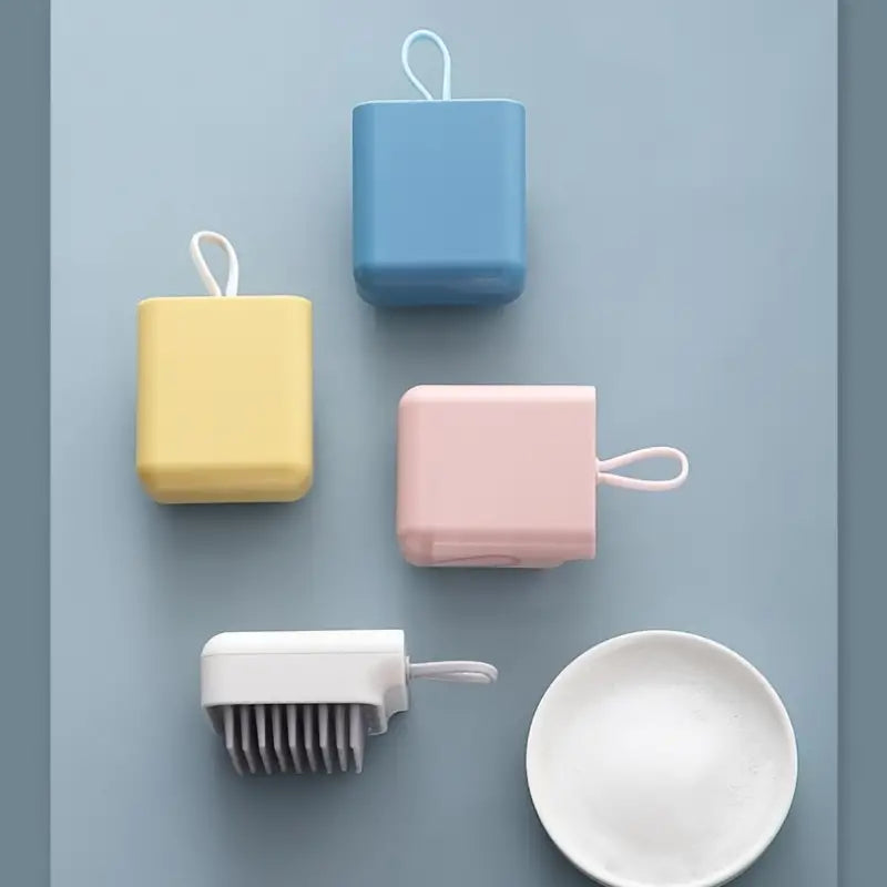 Scalp massage brush in light blue, light pink, bright yellow and gray white