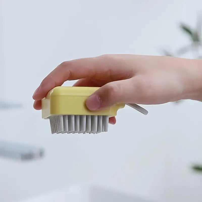 Hand holding the scalp massage brush by its grip